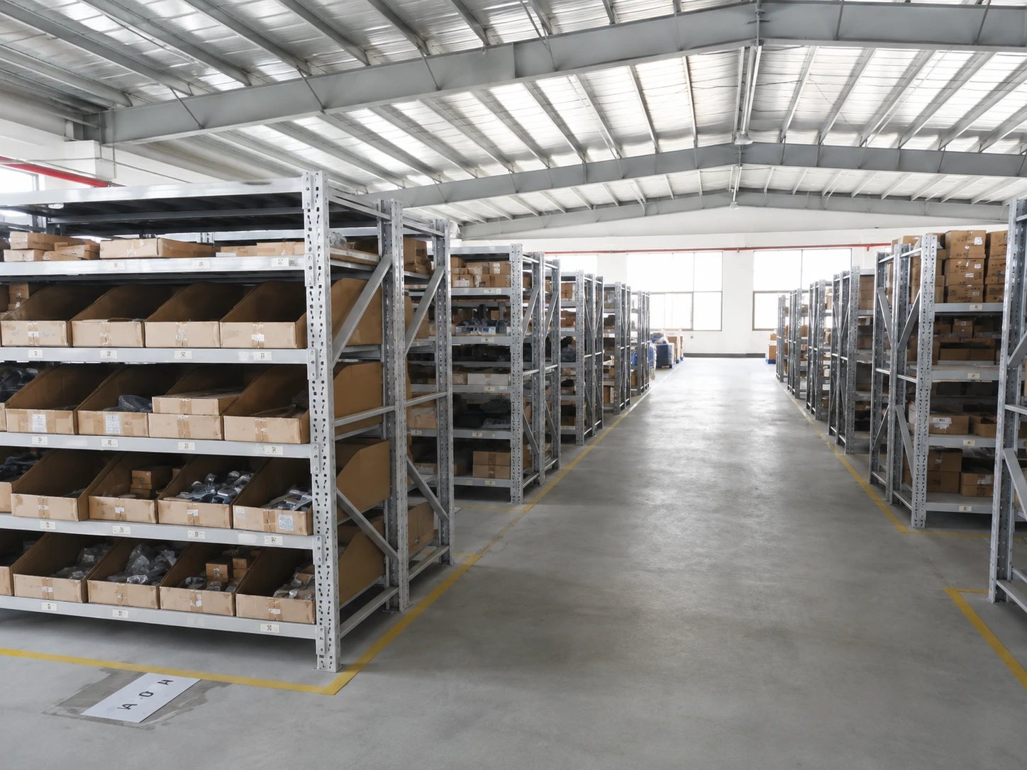 Racking aisles of labelled pick bins running the length of the Palace Shenzhen warehouse